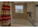 Bathroom with tub, tile surround and shower curtain at 14073 Jennifer Ter, Largo, FL 33774