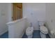 View of a toilet and bidet in a simple bathroom with blue tile at 14073 Jennifer Ter, Largo, FL 33774