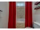 Bathroom featuring jacuzzi tub with red curtains with a tiled backsplash at 14073 Jennifer Ter, Largo, FL 33774