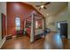 Spacious bedroom with four-poster bed, hardwood floors, and ample natural light at 14073 Jennifer Ter, Largo, FL 33774