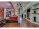 Large primary bedroom featuring wood floors, vaulted ceiling, fireplace, and custom built-ins at 14073 Jennifer Ter, Largo, FL 33774