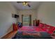 Bright bedroom with ceiling fan, hardwood floors and a large window at 14073 Jennifer Ter, Largo, FL 33774