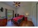 Comfortable bedroom with ceiling fan, hardwood floors and large window at 14073 Jennifer Ter, Largo, FL 33774