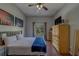 Bedroom featuring hardwood floors, ceiling fan and a window with backyard view at 14073 Jennifer Ter, Largo, FL 33774