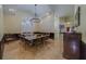 Bright dining room features a dining table with seating for fourteen, with beautiful natural lighting at 14073 Jennifer Ter, Largo, FL 33774