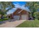 Attractive exterior of home showcasing a multi-car garage, well-manicured lawn, and mature trees at 14073 Jennifer Ter, Largo, FL 33774