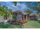Charming single-Gathering home showcasing lush landscaping, brick accents, and an inviting entrance at 14073 Jennifer Ter, Largo, FL 33774