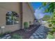 Exterior view of house with flower beds alongside a black and white stone walkway at 14073 Jennifer Ter, Largo, FL 33774