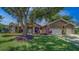 Charming single-story home with a well-manicured lawn and mature landscaping in a desirable neighborhood at 14073 Jennifer Ter, Largo, FL 33774