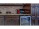 Kitchen beverage bar features a beverage refrigerator with counter space and storage at 14073 Jennifer Ter, Largo, FL 33774