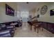 Elegant living room featuring a grand piano and a view of the front entrance at 14073 Jennifer Ter, Largo, FL 33774
