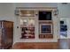 Living room with custom shelving, a fireplace, and hardwood floors at 14073 Jennifer Ter, Largo, FL 33774