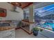 The outdoor kitchen has a grill, sink, and countertop with a view of the pool at 14073 Jennifer Ter, Largo, FL 33774