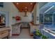 The outdoor kitchen features stainless steel appliances, stone countertops, and a bar area at 14073 Jennifer Ter, Largo, FL 33774