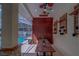 A covered patio offers a wooden table, ceiling fans, and view of the screened pool at 14073 Jennifer Ter, Largo, FL 33774