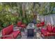 Outdoor patio area featuring a fire pit and seating surrounded by lush tropical landscaping at 14073 Jennifer Ter, Largo, FL 33774