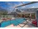 A refreshing, screened-in outdoor pool and spa at 14073 Jennifer Ter, Largo, FL 33774