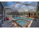 Outdoor pool and spa surrounded by covered seating areas at 14073 Jennifer Ter, Largo, FL 33774
