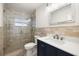 Updated bathroom features a glass-enclosed shower, modern vanity, and stylish tile work throughout at 14917 Philmore Rd, Tampa, FL 33613