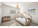 Cozy bedroom with tiled floors, a small wooden bed and a whimsical, overhead light fixture at 14917 Philmore Rd, Tampa, FL 33613