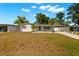 Charming single-story home features a well-maintained front yard, mature trees, and a covered carport at 14917 Philmore Rd, Tampa, FL 33613