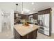 Modern kitchen features a center island, granite countertops, stainless steel appliances, and ample cabinet space at 14917 Philmore Rd, Tampa, FL 33613