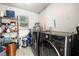 Functional laundry room with appliances, storage shelves and tiled floor at 14917 Philmore Rd, Tampa, FL 33613