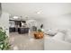 Open-concept layout showcases a bright living room with tile flooring, a stylish sofa, and contemporary decor at 14917 Philmore Rd, Tampa, FL 33613