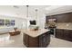 Contemporary kitchen with a center island seamlessly flows into the living room, perfect for entertaining guests at 14917 Philmore Rd, Tampa, FL 33613