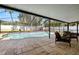 Relaxing screened-in pool area with tiled patio, seating, and well-maintained pool at 14917 Philmore Rd, Tampa, FL 33613