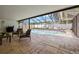Outdoor living with view of screened pool and stone-tiled patio, perfect for entertaining guests at 14917 Philmore Rd, Tampa, FL 33613