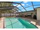 Beautiful screened pool in the backyard with a stone patio and room for outdoor living and entertaining at 14917 Philmore Rd, Tampa, FL 33613