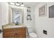Bathroom with wood vanity, granite countertop, rustic mirror, and decorative wall art at 1502 Creekbend Dr, Brandon, FL 33510