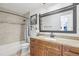 Charming bathroom with a modern vanity, decorative mirror, and stylish shower and tub at 1502 Creekbend Dr, Brandon, FL 33510