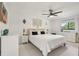 Modern bedroom with soft decor, ample natural light, ceiling fan and simple furniture at 1502 Creekbend Dr, Brandon, FL 33510