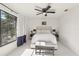 Bright bedroom features natural light, comfortable bed, ceiling fan, and bedside table at 1502 Creekbend Dr, Brandon, FL 33510