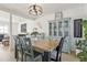 Dining room with rustic wooden table, blue accents, view into the living area, and modern light fixture at 1502 Creekbend Dr, Brandon, FL 33510