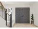 Elegant foyer features grand double doors, staircase, and tasteful décor, creating a welcoming ambiance at 1502 Creekbend Dr, Brandon, FL 33510