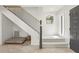 Spacious entryway with staircase, modern black railings, and cozy nook under the stairs, great for pets at 1502 Creekbend Dr, Brandon, FL 33510