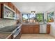 Kitchen featuring wood cabinetry, granite counters, stainless appliances, and a garden window at 1502 Creekbend Dr, Brandon, FL 33510