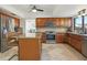 Spacious kitchen with island seating, stainless steel appliances, and wood cabinetry at 1502 Creekbend Dr, Brandon, FL 33510
