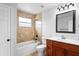Bathroom featuring tiled shower and tub combo and wood vanity at 1506 Lenton Rose Ct, Trinity, FL 34655