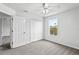 Bedroom features a carpet, ceiling fan, and closet at 1506 Lenton Rose Ct, Trinity, FL 34655