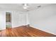 Bright bedroom features wood floors, a ceiling fan, and two closets for ample storage at 1506 Lenton Rose Ct, Trinity, FL 34655