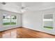 Bright bedroom featuring hardwood floors and well-lit windows with a view of the outdoors at 1506 Lenton Rose Ct, Trinity, FL 34655