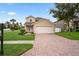 Charming two-story home with brick driveway and well-manicured lawn under a sunny blue sky at 1506 Lenton Rose Ct, Trinity, FL 34655