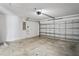 Spacious garage featuring a garage door and plenty of room for storage at 1506 Lenton Rose Ct, Trinity, FL 34655