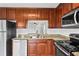 Updated kitchen with granite counters, stainless steel appliances, and dark wood cabinets at 1506 Lenton Rose Ct, Trinity, FL 34655