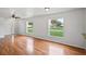 Bright and airy living room featuring hardwood floors and large windows that let in plenty of natural light at 1506 Lenton Rose Ct, Trinity, FL 34655