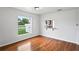 Cozy living area with hardwood floors, a pass-through window to the kitchen, and bright natural light at 1506 Lenton Rose Ct, Trinity, FL 34655